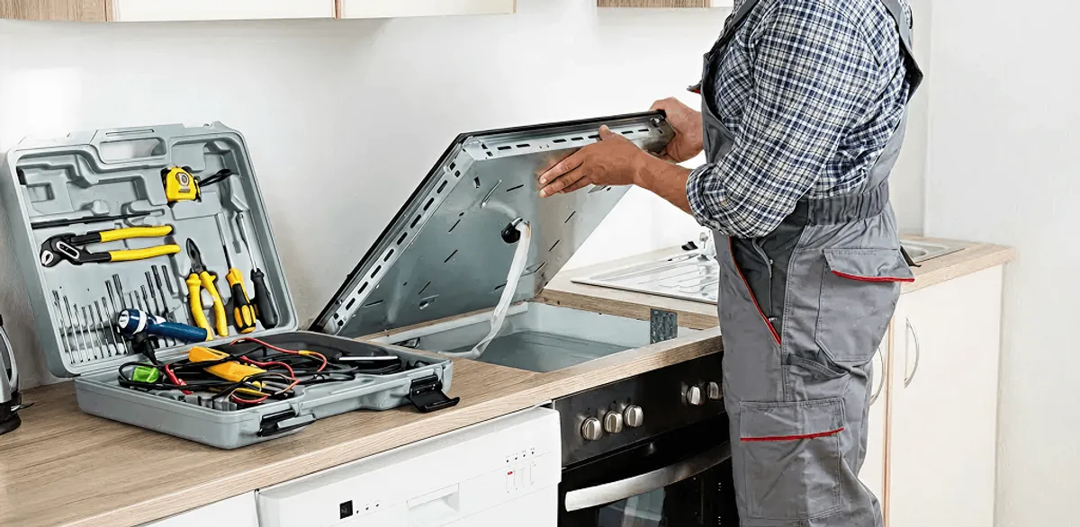 Handyman repairing a cooktop and checking wiring connections in Albany, NY