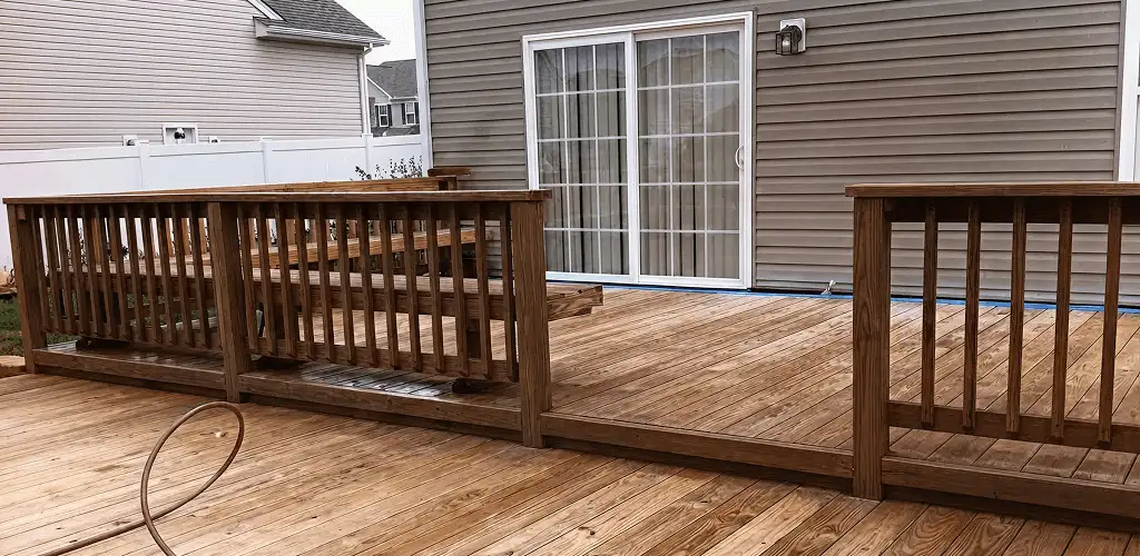 Deck sealing service protecting a backyard wood deck and railings in Albany, NY