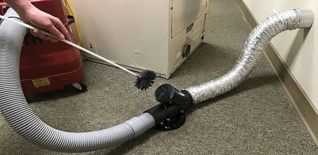 Dryer vent cleaning service removing lint from a dryer duct connection in Albany, NY