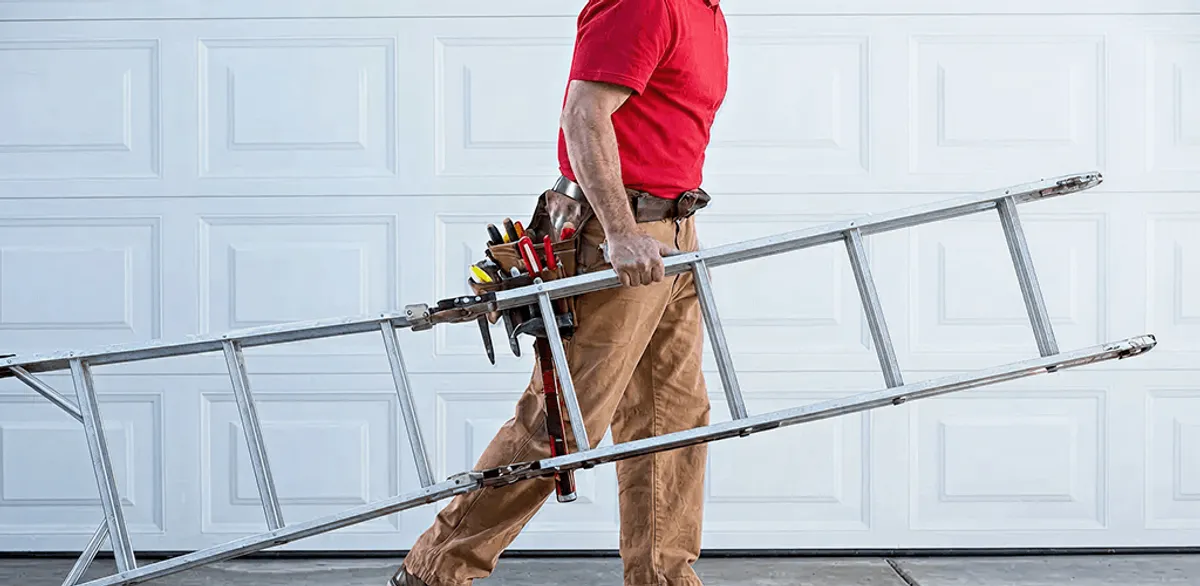 Garage door repair technician arriving with tools and ladder in Albany, NY