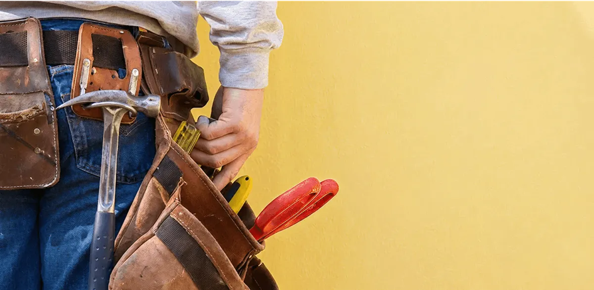 Handyman with tool belt ready for home repairs and maintenance in Albany, NY