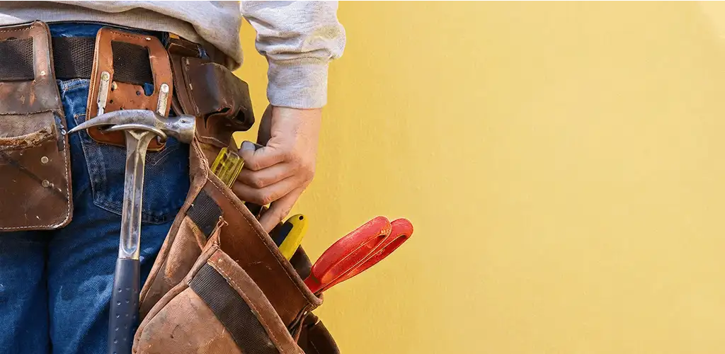 Handyman with tool belt ready for home repairs and maintenance in Albany, NY