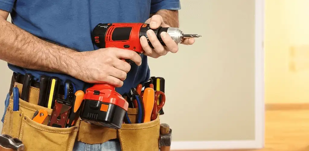 Handyman holding a power drill for home repairs and installations in Albany, NY