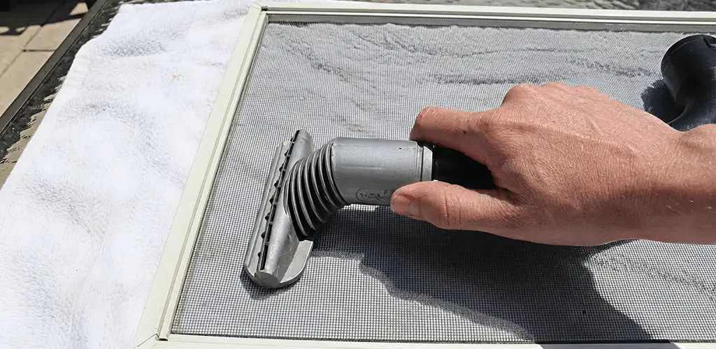 Window screen repair cleaning and fixing a damaged screen mesh in Albany, NY