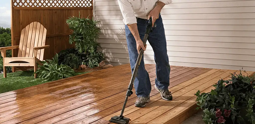 Deck staining service applying stain to a backyard wood deck in Albany, NY